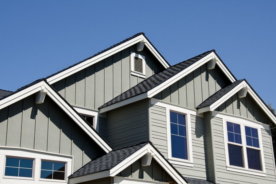 Residential house with professionally installed shingle roof, roofing installation and repair services